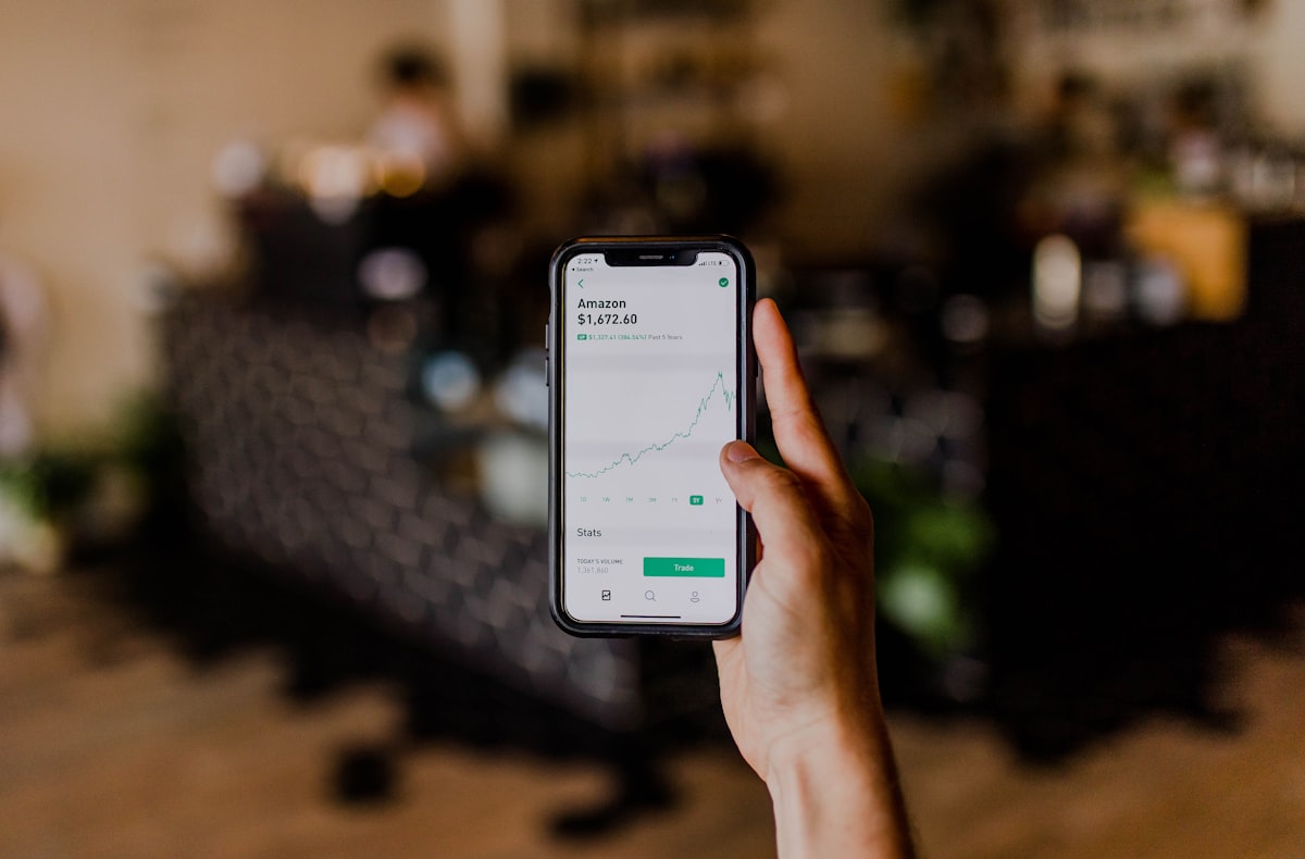 Person using a budgeting app on their phone with charts