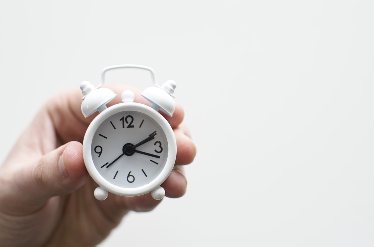 Hourglass with sand flowing representing time as the key factor in compound interest growth