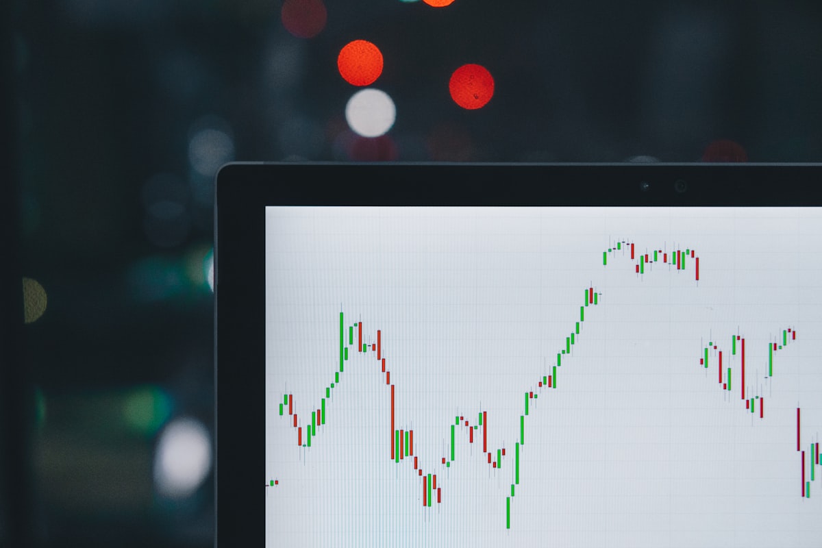 Person tracking diversified investments on a laptop and phone