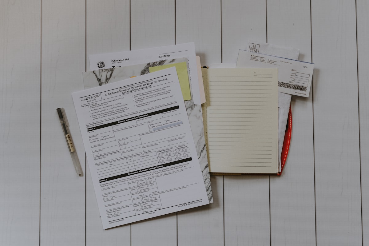 Person reviewing tax documents and receipts at a desk with calculator